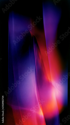 Vibrant abstract light trails in shades of purple and red against a dark background