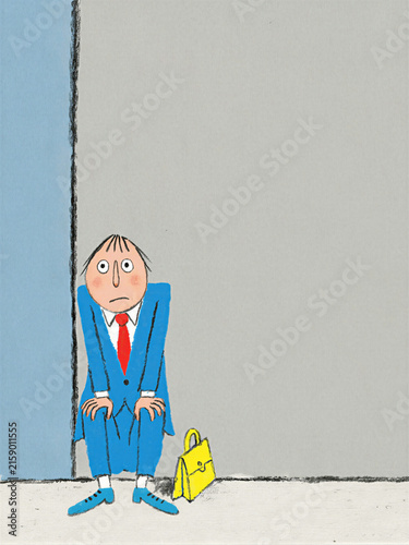 Sad businessman sitting against wall with briefcase