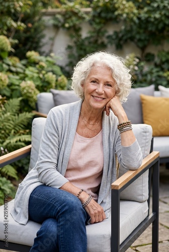 Happy senior woman relaxing in a beautiful garden