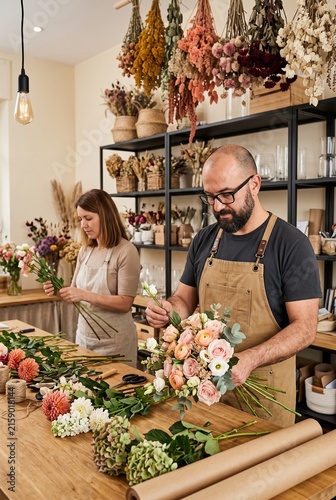 Florists creating elegant bouquets in a modern flower shop
