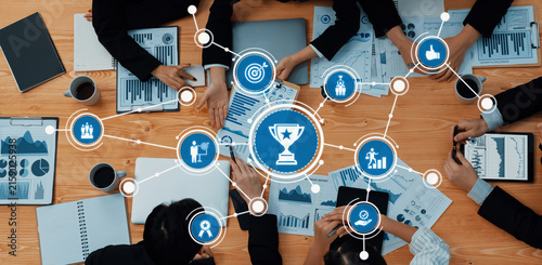 Aerial view of a collaborative business meeting with professionals analyzing charts and reports  focused on strategic planning  goal setting  and achieving success together. Amity