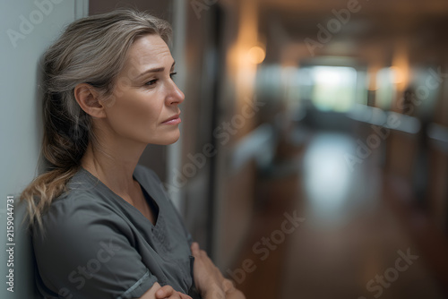 Caregiver resting in quiet hospital hallway