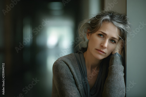 Caregiver in hallway resting after long day