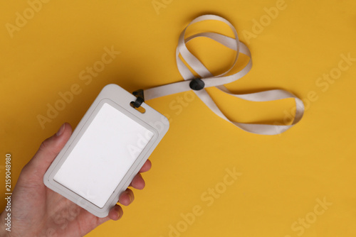 Cuadro en lienzo Hand holding ID card on yellow background