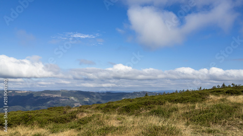 Принти на полотні Mountain landscape with dry meadow under clear blue sky