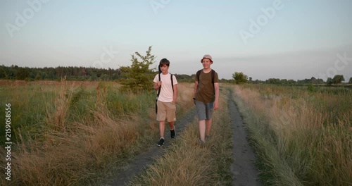 Two friends boys hike walking on nature. Teenagers spending time together. 4K 10-bit