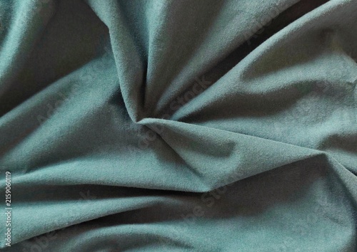 Cuadro en lienzo Background view of softly draped teal blue-green fabric with natural folds and gathered texture, creating an elegant abstract textile backdrop with subtle shadows, rich depth, and dimensional detail