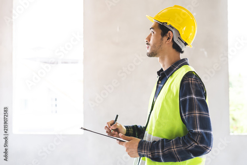 Building inspection asian contractor young man, male inspecting home, reconstructed construction, renovation or check defect, before finish handing it over to client, customer. Engineering worker.
