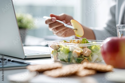 Professional Eating Healthy Salad Lunch at Desk with Laptop