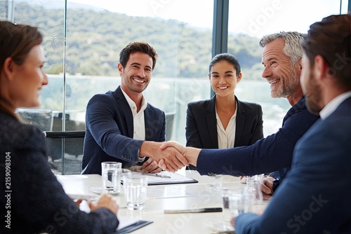 Business Team Shakes Hands in Modern Office Meeting