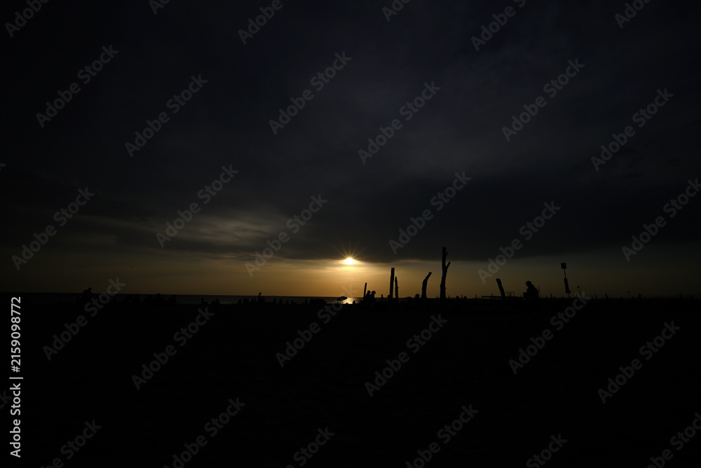 Obraz premium Torre del Lago, Tuscany, Italy - August 12th 2026 - People at the beach looking at the partial solar eclipse.