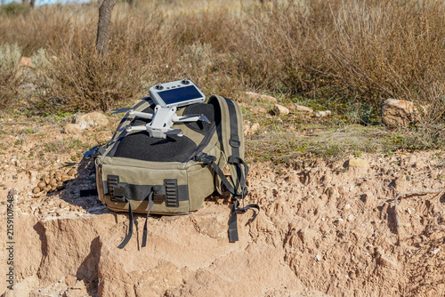 Tapety artystyczne Drone and remote controller on backpack in la rioja vineyard