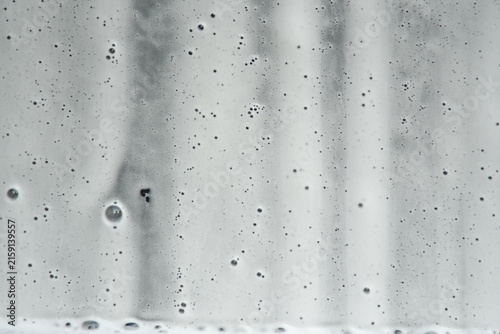 Canvas Print Abstract monochrome white soap foam lather background on transparent glass, clea
