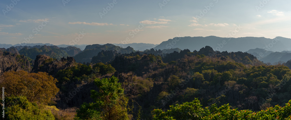 Fototapeta premium Panoramic Karst Mountains and Forest Beneath Blue Sky