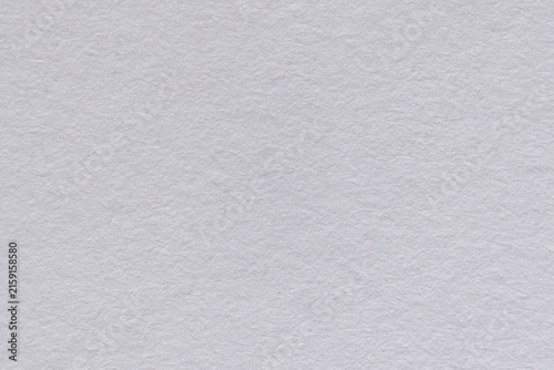 White Textured Paper Surface Showing Fine Fiber Grain And Subtle Shading In Close Up Studio Flatlay Background For Material Texture And Backdrop Use In Design.