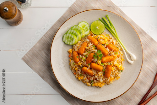mini cocktail sausage fried rice.Thai fried rice with egg ,carrot and pork sausage in a plate.Top view.