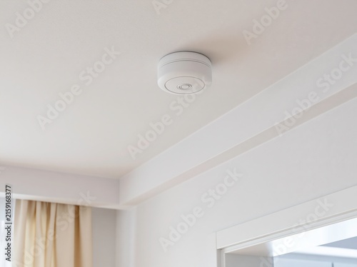 Obraz na płótnie Small discreet elderly fall detection radar sensor mounted in a bedroom corner