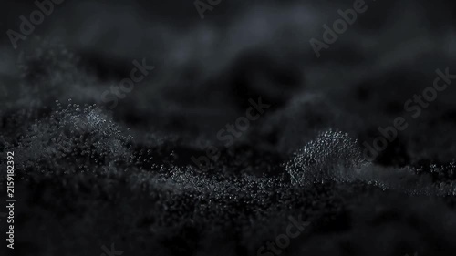 Abstract dark liquid motion with glowing particle waves flowing through black space creates cinematic background footage for technology and science visuals.