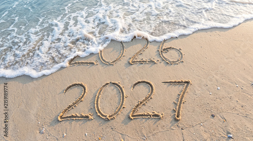 2027 desk calendar on sandy beach at sunset, new year planning concept, scenic ocean coast background isolated on White Background