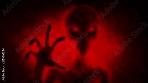 Creepy alien humanoid silhouette in light. 2D animation in sci-fi horror genre. Red background color. Vj loop video. Spooky animated short film. Gloomy ghost in haze.