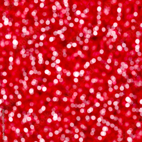 Red glitter bokeh background with sparkling defocused lights