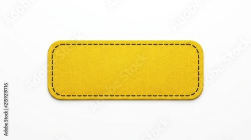 Yellow fabric patch with stitched border rests on a white background sewn rectangle textile material craft applique embroidery closeup