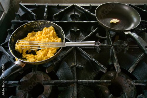 Принти на полотні Scrambling eggs in a frying pan on a gas stove
