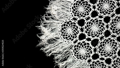 Crochet lace patterns border, crocheted Grandma's Doily, detail of hand-crocheted embroidery, tablecloth, napkin isolated on black background border art design. Craft, vintage linen. Hobby concept
