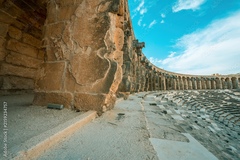 Fototapeta premium Aspendos grand stone arches standing as a testament to monumental Roman engineering and timeless power in Antalya, Turkiye.
