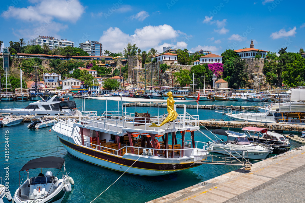 Fototapeta premium Colorful passenger boats in the historic Antalya harbor, Turkey.