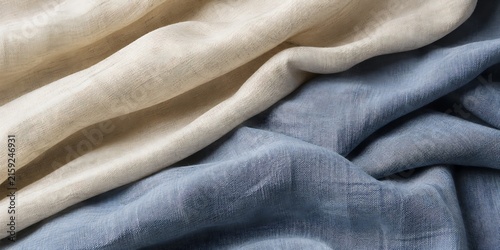 Textured linen fabric in natural beige and soft blue draped with gentle folds under soft studio light showcasing a luxurious textile