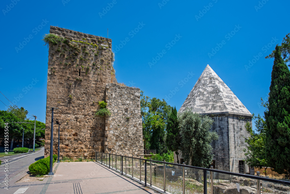 Fototapeta premium Historic stone tower and domed building in Kaleici Old Town, Antalya, Turkey.