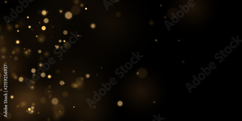 фотографія Glowing golden dust swirls through black space