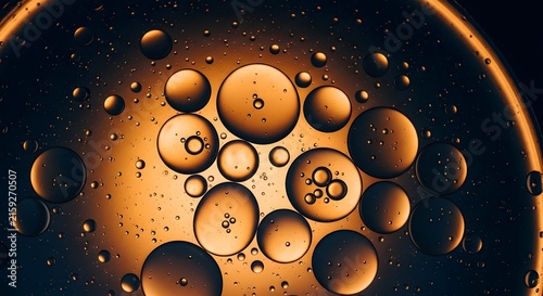 Macro Bubbles Abstract: Close-up view of oil and water droplets, illuminated with warm golden and orange hues, creating a mesmerizing abstract pattern of spheres and clusters.