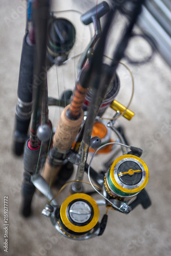 Top view of multiple spinning fishing rods and reels grouped together