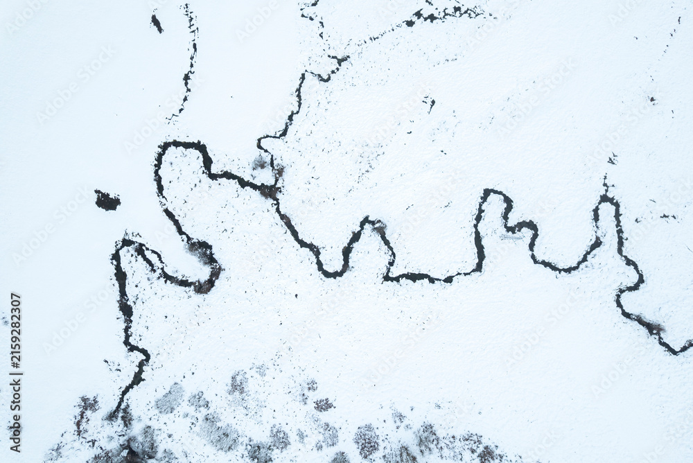 Obraz premium Aerial top down view of river in snowy landscape The Concept of solitude