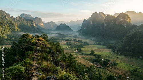 Dramatic landscape with misty mountains and lush green valleys at sunrise southeast asia