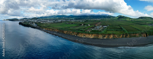 Aerial panoramic view of Praia de Santa Barbara, a long sandy surf beach on the north coast of Sao Miguel, Azores, Portugal.