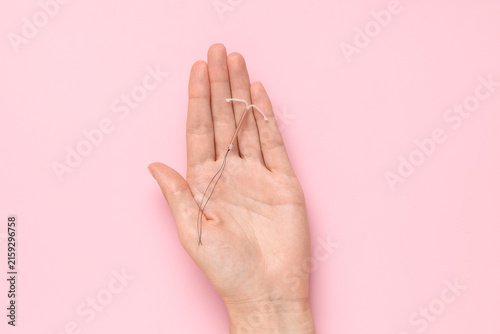 Canvastavla Intrauterine device (IUD) for contraception and family planning held in a hand o