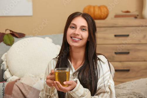 Young woman with cup of gre...