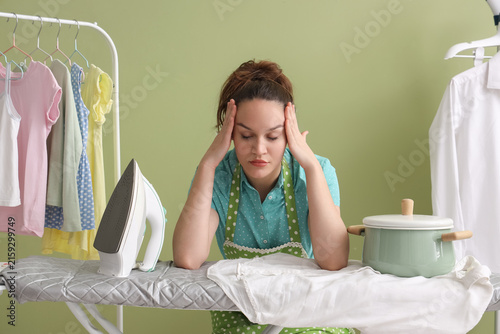 Tired young woman with cook...