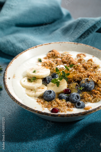 Eating granola with greek yogurt and berries