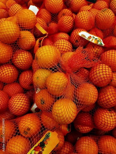 Konstfotografi Oranges, likely packaged for sale in mesh bags.
