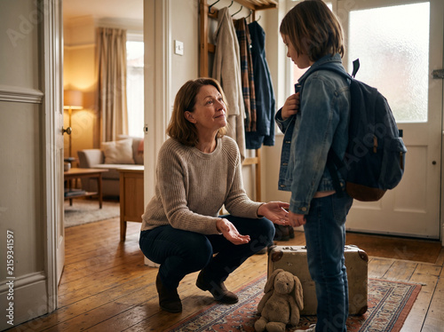 Foster carer welcoming a child into her home