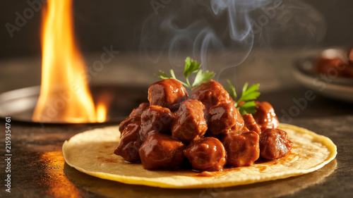 Steaming Meat Dish on Tortilla with Flames in Background food cooking