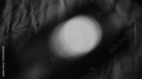 Dark abstract moody background with soft bokeh lights and fabric texture abstract background mysterious illumination material