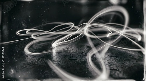 Abstract long exposure light painting photography showing glowing trails loops and curves in the dark with painting exposure abstract