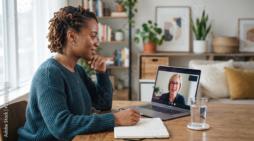 African American woman attending online therapy session with counselor at home. Mental health support, emotional wellbeing and accessible telehealth consultation