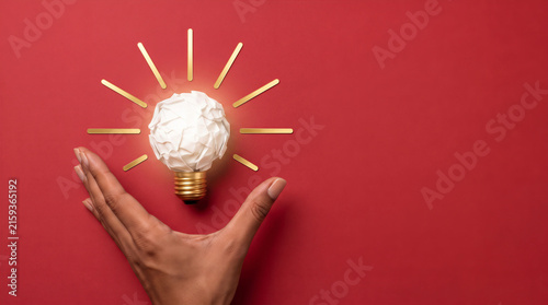 Hand holding a glowing lightbulb for Idea and innovation concept