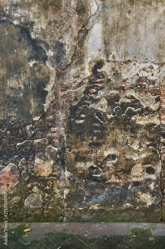 Фотография Old brick wall texture with weathered plaster and dampness